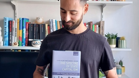 Ilias Alami with book