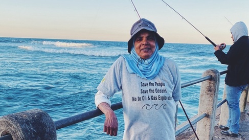 "A subsistence fisherwoman at the beginning of the evening shift. She wears a t-shirt from a protest march that reads; “Save the People Save the Oceans No to Oil & Gas Exploration” by Nikita Hiralal, PhD candidate.
